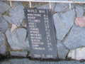 Close up view of the plaques at the bottom of a pieta sculpture of the Virgin Mary holding the dead body of Christ in her arms. The plaques list the names of men who died during the First World War.